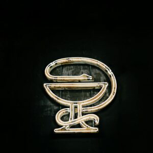 A coiled serpent symbolizing medicine and representing health and wellness.